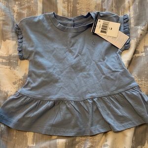 Peplum polo tee with eyelet trim